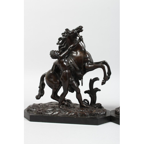 1251 - A SUPERB PAIR OF BRONZE HORSES AND ATTENDANTS on marble bases. 11ins high.