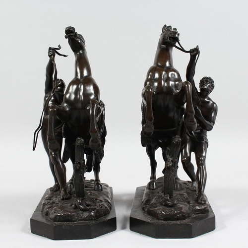 1251 - A SUPERB PAIR OF BRONZE HORSES AND ATTENDANTS on marble bases. 11ins high.