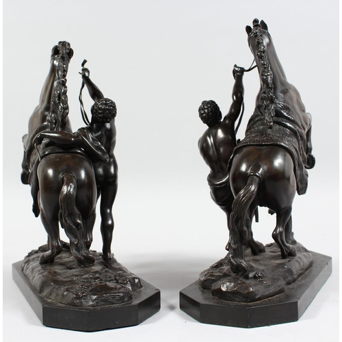 1251 - A SUPERB PAIR OF BRONZE HORSES AND ATTENDANTS on marble bases. 11ins high.