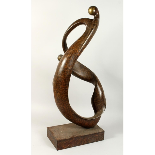 1254 - A LARGE ABSTRACT BRONZE, ENTWINED FIGURES on a rectangular base. 34ins high.