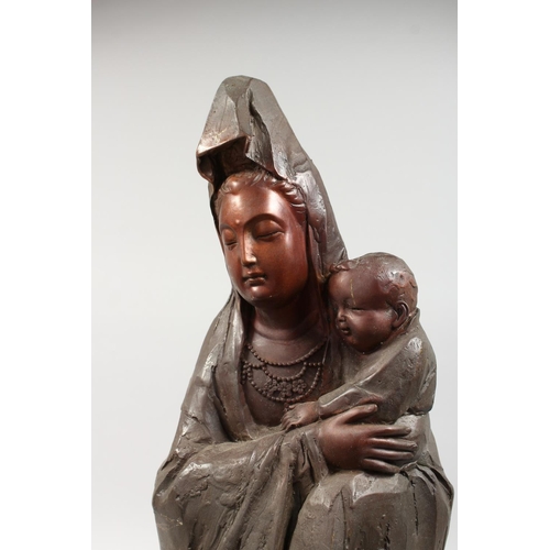 1259 - A LARGE BRONZE OF A LADY HOLDING A BABY. 23ins high.