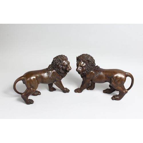 1263 - A PAIR OF BRONZE STANDING LIONS 12.5ins high.