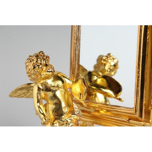 1271 - A GOOD SMALL GILT BRONZE TABLE MIRROR with cherubs mount. 9ins high.