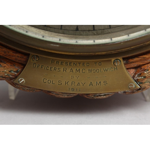 1288 - A GOOD OAK CASED CIRCULAR CLOCK with silvered dial, 7.5ins diameter, presented to Officers RAMC, Woo... 