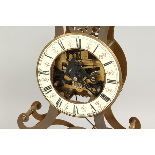 1290 - A MOONPHASE BRASS SKELETON CLOCK. 17ins in a glass case.