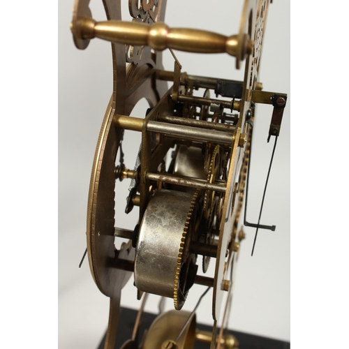 1290 - A MOONPHASE BRASS SKELETON CLOCK. 17ins in a glass case.