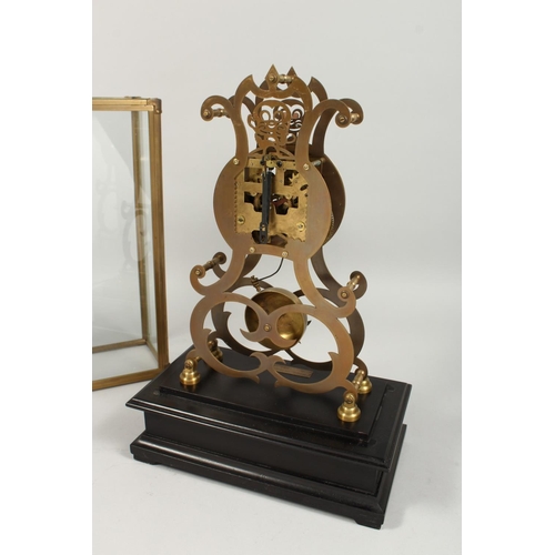 1290 - A MOONPHASE BRASS SKELETON CLOCK. 17ins in a glass case.