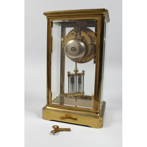 1299 - A BRASS FOUR GLASS MANTLE CLOCK with eight day movement striking on a bell, enamel dial with Roman n... 