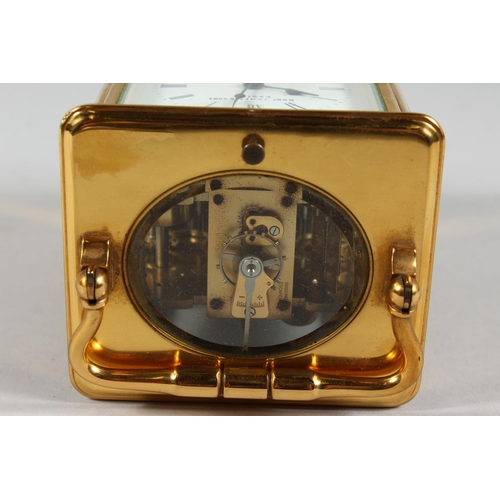 1311 - A FRENCH BRASS CARRIAGE CLOCK with eight day movement, striking on a gong enamel dial with subsidiar... 