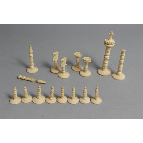 1326 - A CHESS SET in a wooden box, with black and white ivory chess pieces.