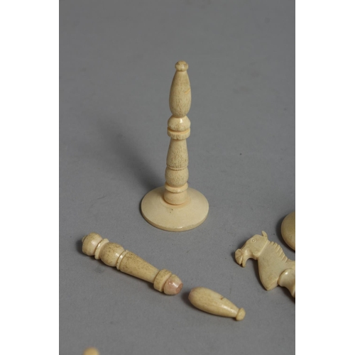 1326 - A CHESS SET in a wooden box, with black and white ivory chess pieces.