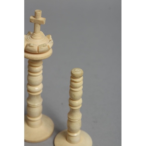 1326 - A CHESS SET in a wooden box, with black and white ivory chess pieces.