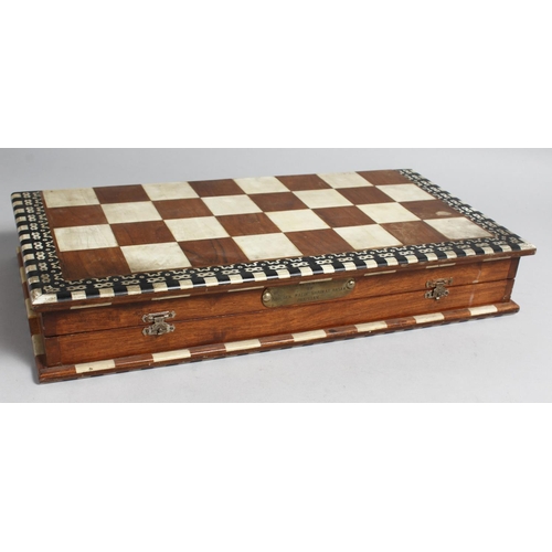 1326 - A CHESS SET in a wooden box, with black and white ivory chess pieces.