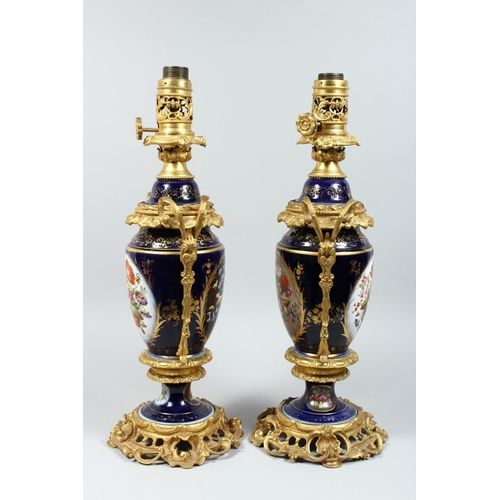 1335 - A PAIR OF PARIS PORCELAIN AND ORMOLU MOUNTED URN SHAPED TABLE LAMPS, painted with panels of flowers ... 