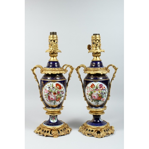 1335 - A PAIR OF PARIS PORCELAIN AND ORMOLU MOUNTED URN SHAPED TABLE LAMPS, painted with panels of flowers ... 