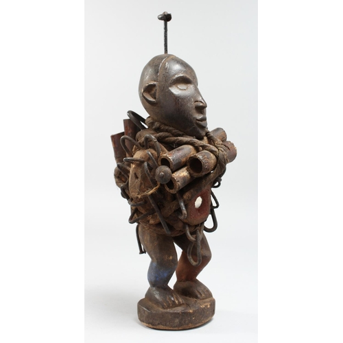 1342 - AN AFRICAN CARVED WOOD FIGURE with tubes and nails.  12ins high.