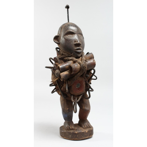 1342 - AN AFRICAN CARVED WOOD FIGURE with tubes and nails.  12ins high.