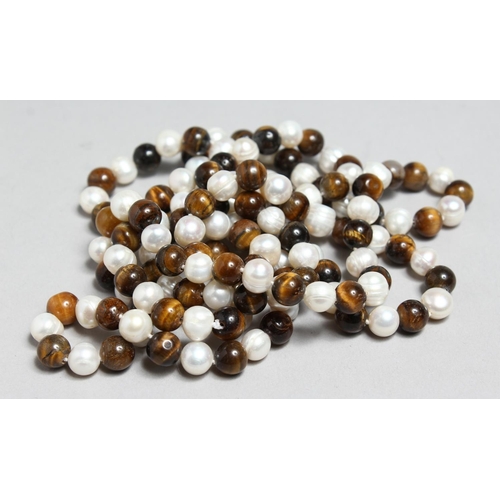 1710 - A STRING OF PEARL AND TIGER'S EYE BEADS, 45ins long.