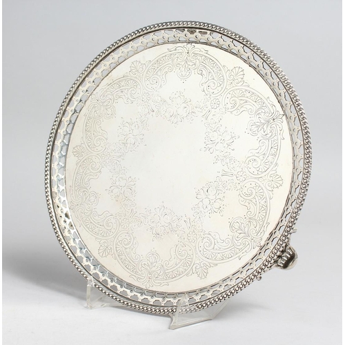 2042 - A GOOD VICTORIAN ENGRAVED CIRCULAR SALVER with pierced border, 8.75in diameter, London 1867, maker S... 