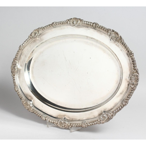 2045 - A GEORGE IV SILVER OVAL MEAT DISH with gadrooned and shell border, 17ins long. London 1823, maker R.... 