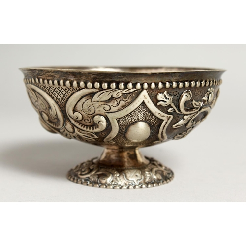 2046 - A CONTINENTAL SILVER EMBOSSED CIRCULAR PEDESTAL BOWL.