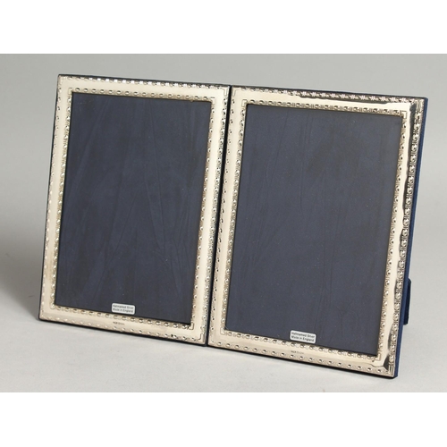 2051 - A LARGE PAIR OF SILVER PHOTOGRAPH FRAMES. 19cm x 14cm.