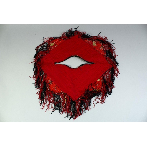 28 - A TURKAMAN BABY PONCHO, all over embroidered design with fringed edge, approx. 37cm diameter.