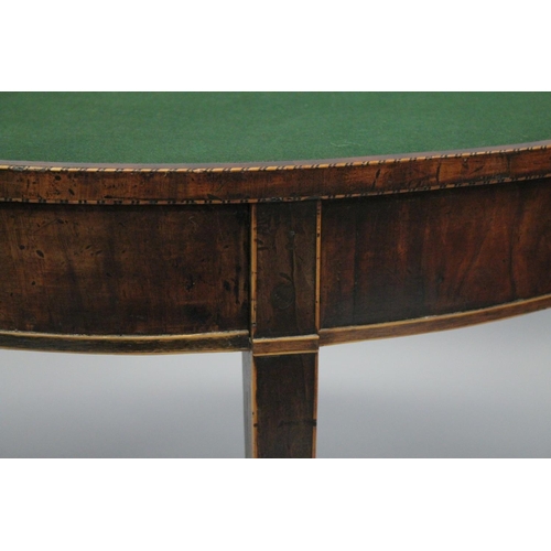 1002 - A GOOD GEORGE III MAHOGANY DEMI-LUNE FOLD OVER CARD TABLE with tapering legs. 2ft 6ins high x 3ft wi... 