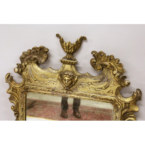 1003 - A GOOD GEORGE III DESIGN CARVED WOOD AND GILDED MIRROR with acanthus scrolls, masks, and urns. 3ft 1... 