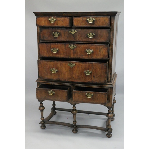 1005 - AN EARLY 17TH CENTURY CHEST ON STAND with a moulded cornice above two short and three graduated long... 