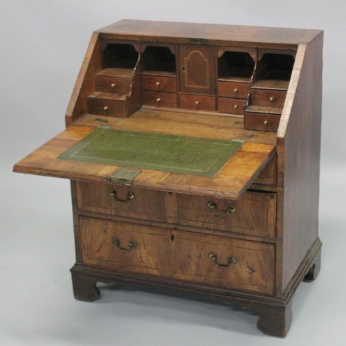 1006 - AN 18TH CENTURY WALNUT FALL FRONT BUREAU with a fitted interior, three small drawers above two gradu... 