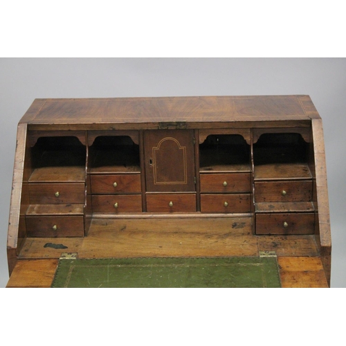 1006 - AN 18TH CENTURY WALNUT FALL FRONT BUREAU with a fitted interior, three small drawers above two gradu... 