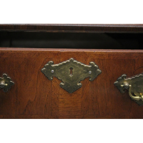 1007 - AN 18TH CENTURY WALNUT CHEST OF DRAWERS with a moulded top, three small drawers above three graduate... 