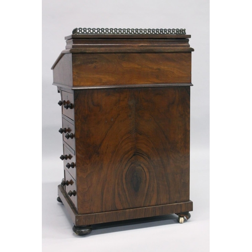 1014 - A GOOD VICTORIAN WALNUT DAVENPORT, brass grill, leather writing surface, fitted interior, four drawe... 