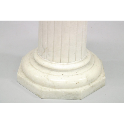 1020 - A MARBLE COLUMN with circular top and octagonal base 27ins high.