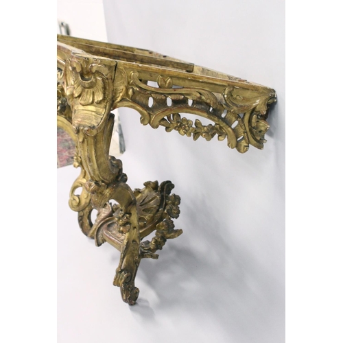 1026 - A VERY GOOD NEAR PAIR OF 18TH CENTURY CARVED AND GILDED CONSOLE TABLES with serpentine marble tops. ... 