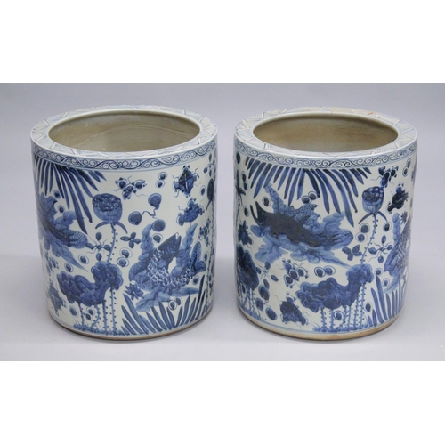 1042 - A PAIR OF CHINESE BLUE AND WHITE POTTERY GARDEN JARDINIERES. 1ft 8ins high.