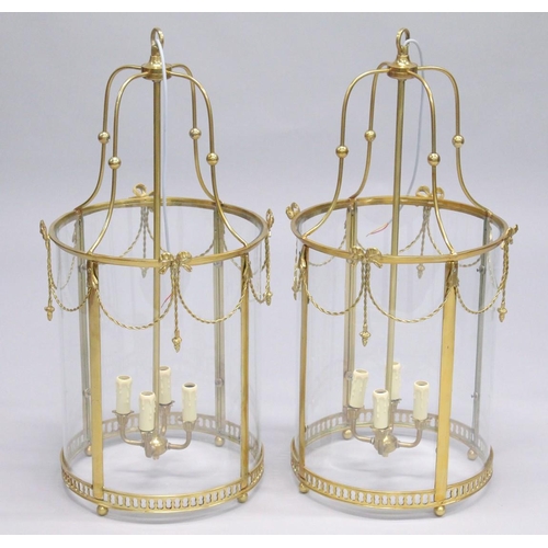 1045 - A PAIR OF GEORGIAN STYLE BRASS AND GLASS CIRCULAR HALL LANTERNS. 2ft 8ins high.