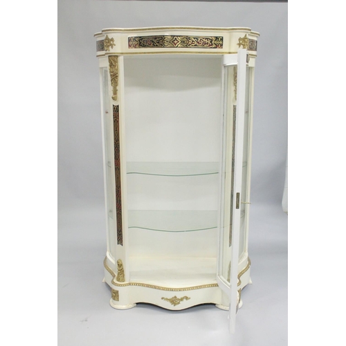 1052 - A FRENCH STYLE WHITE PAINTED STANDING DISPLAY CABINET of 'Serpentine outline inset with 