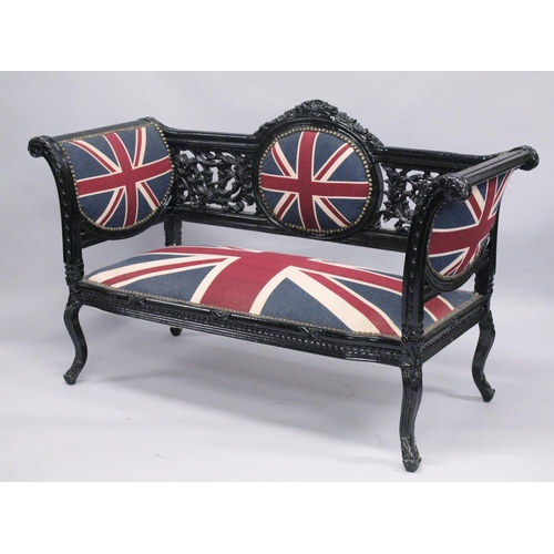 1053 - A VICTORIAN STYLE BLACK PAINTED SCROLL END SETTEE, upholstered with a Union Jack fabric. 5ft long x ... 