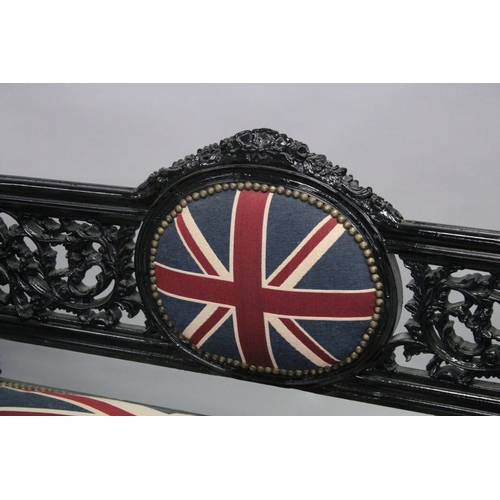 1053 - A VICTORIAN STYLE BLACK PAINTED SCROLL END SETTEE, upholstered with a Union Jack fabric. 5ft long x ... 