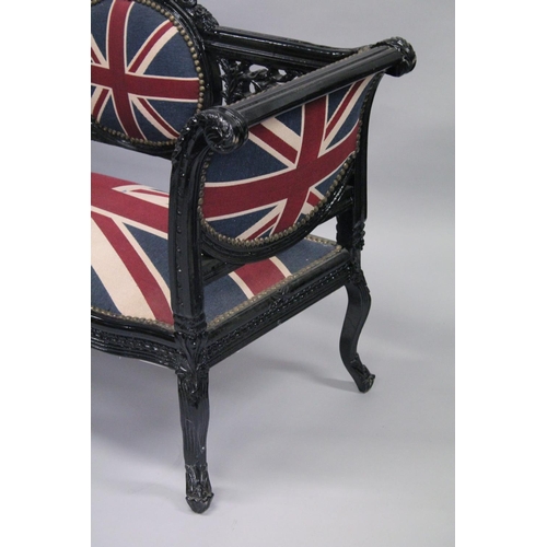 1053 - A VICTORIAN STYLE BLACK PAINTED SCROLL END SETTEE, upholstered with a Union Jack fabric. 5ft long x ... 