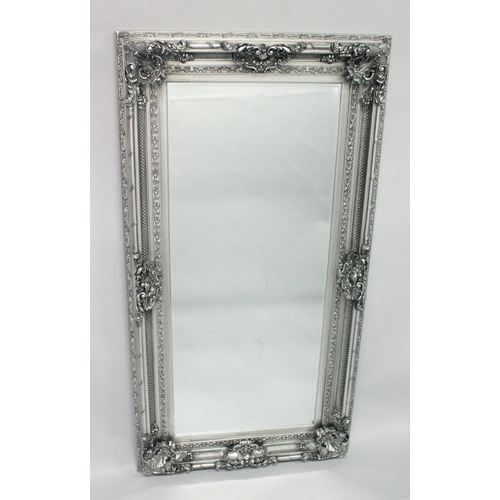 1054 - A LARGE DECORATIVE SILVER FRAMED MIRROR. 6ft x 3ft 2ins.