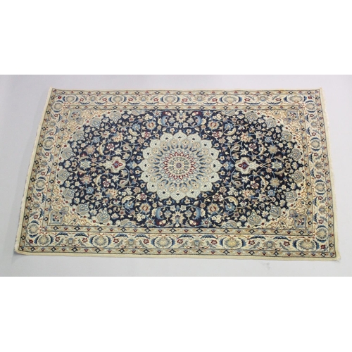 1068 - A PERSIAN RUG blue ground with central loral medallion within a cream ground floral border. 6ft 6ins... 