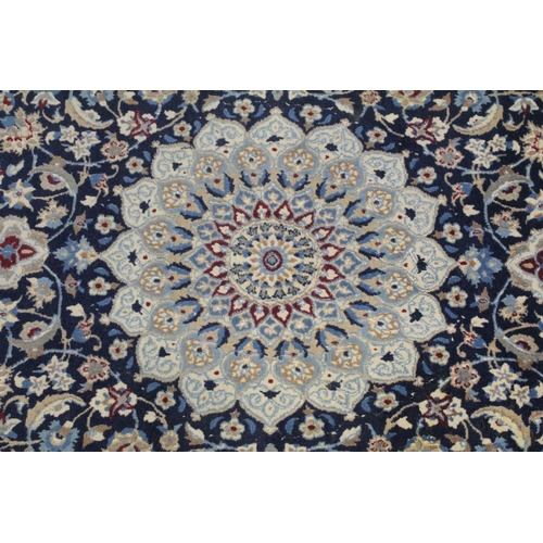 1068 - A PERSIAN RUG blue ground with central loral medallion within a cream ground floral border. 6ft 6ins... 