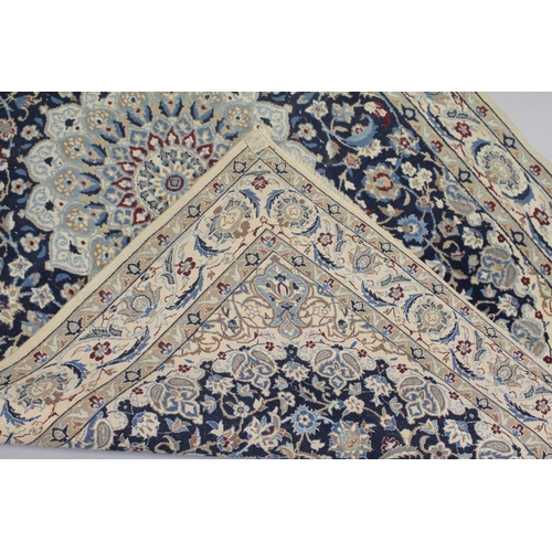 1068 - A PERSIAN RUG blue ground with central loral medallion within a cream ground floral border. 6ft 6ins... 