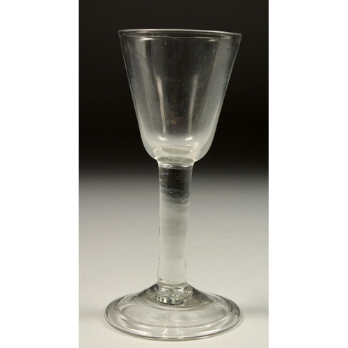 1082 - A GEORGIAN WINE GLASS with plain bowl 6.25ins high.