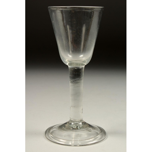 1082 - A GEORGIAN WINE GLASS with plain bowl 6.25ins high.