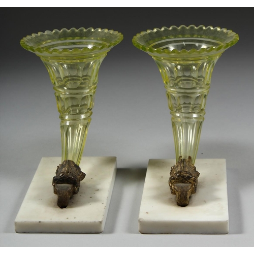 1084 - A GOOD PAIR OF GLASS CORNUCOPIA VASES with ram's masks and marble bases.