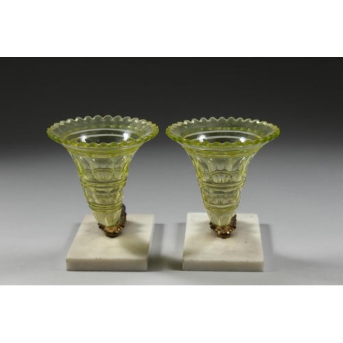 1084 - A GOOD PAIR OF GLASS CORNUCOPIA VASES with ram's masks and marble bases.